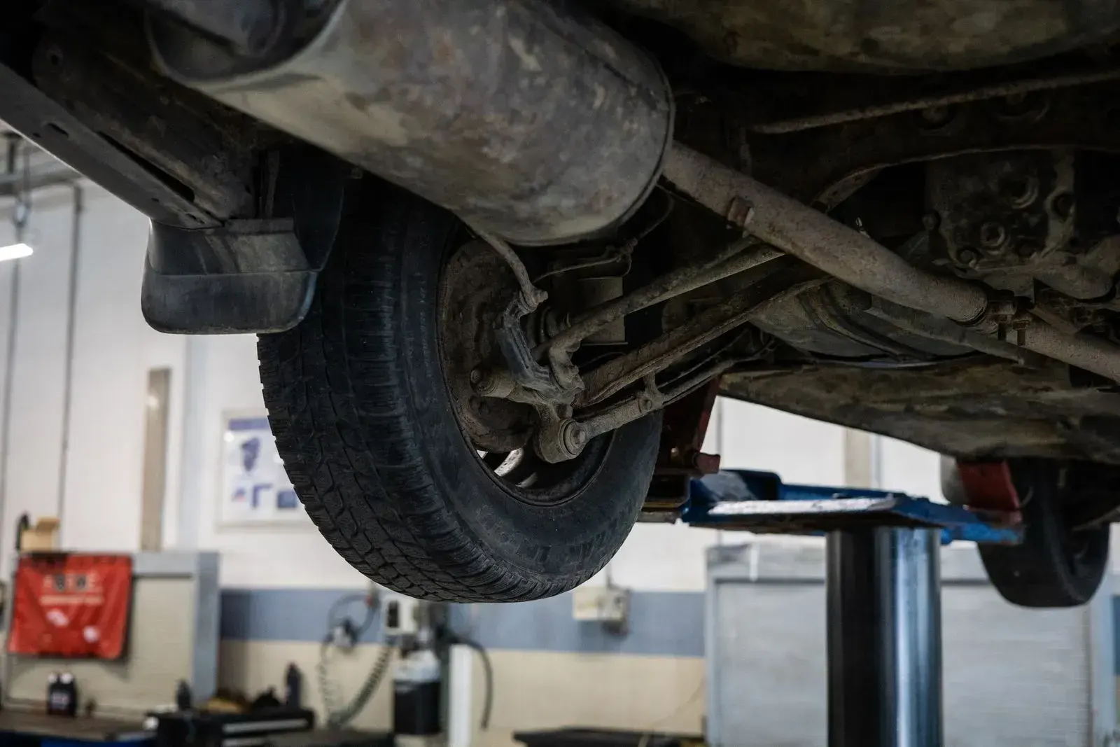 The underside of a car, exhaust and suspension in view.